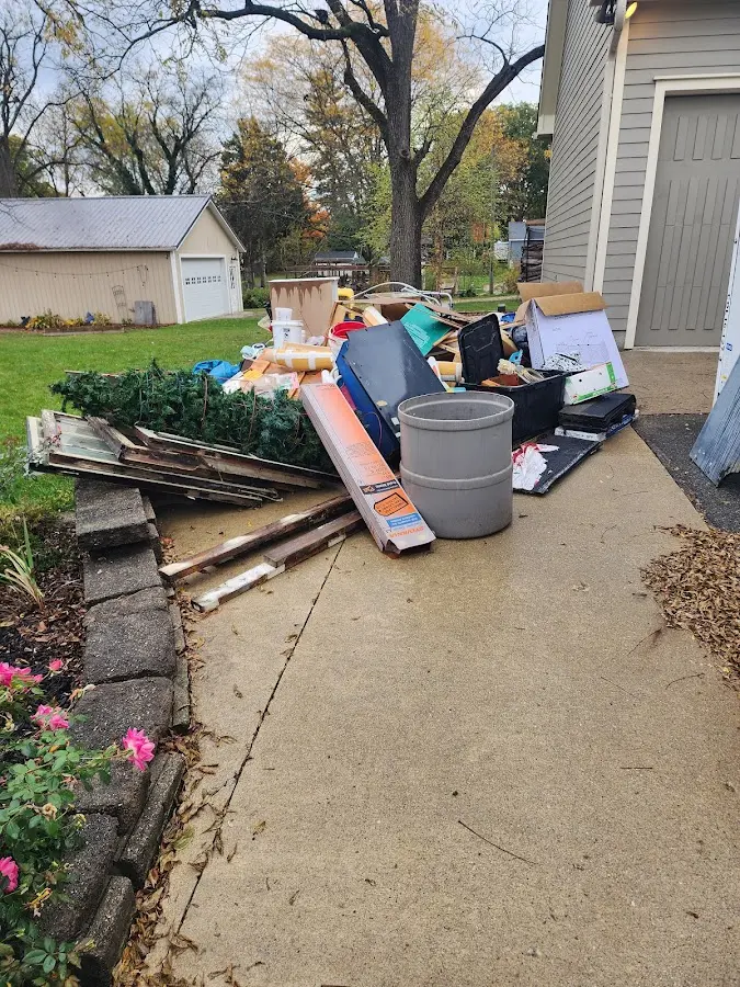 Dumpster being loaded with debris for Roofing Dumpster Rental in Hanover Park